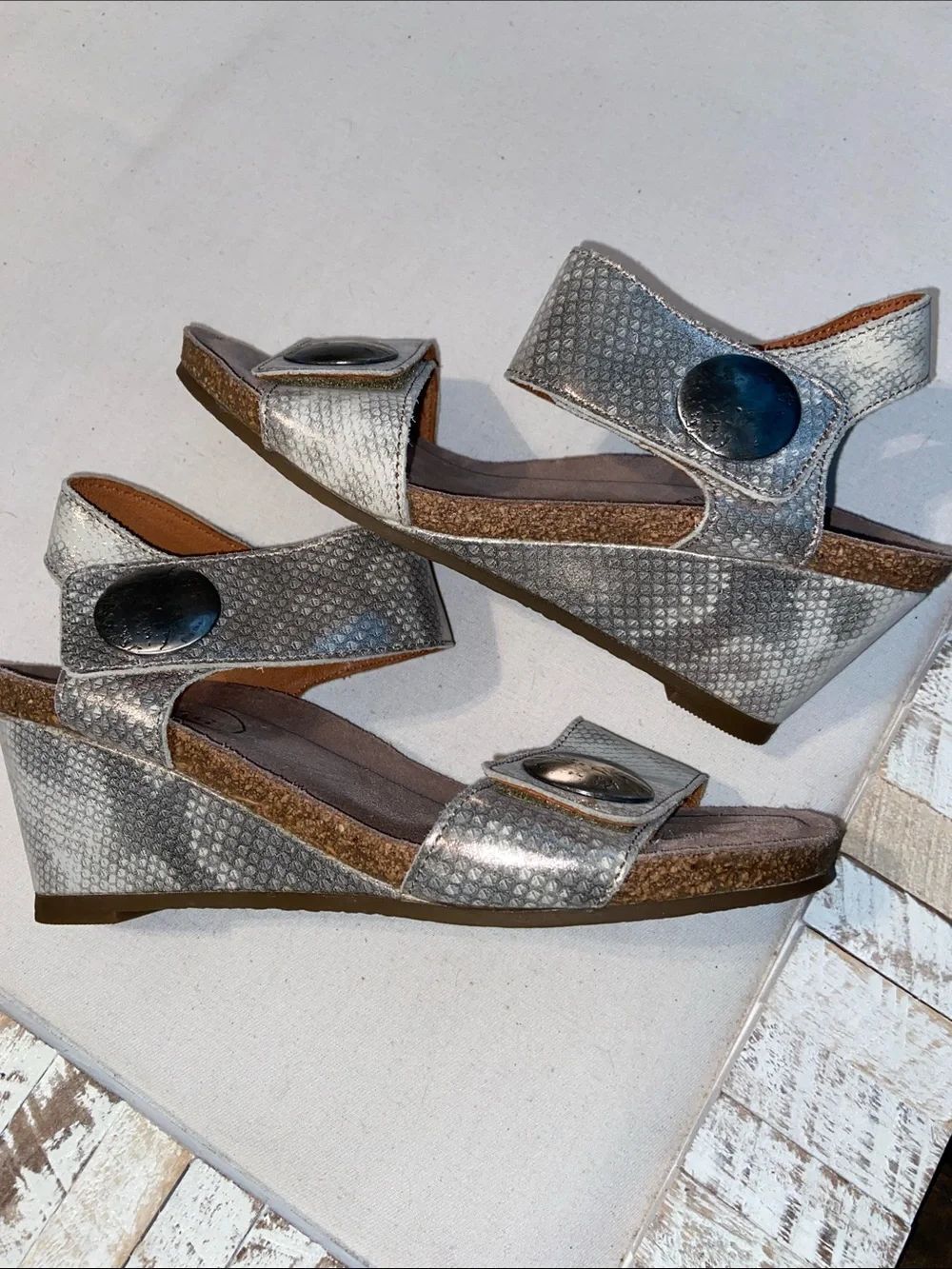 Taos Carousel 2 wedge sandals feature a metallic snake print leather size 5
